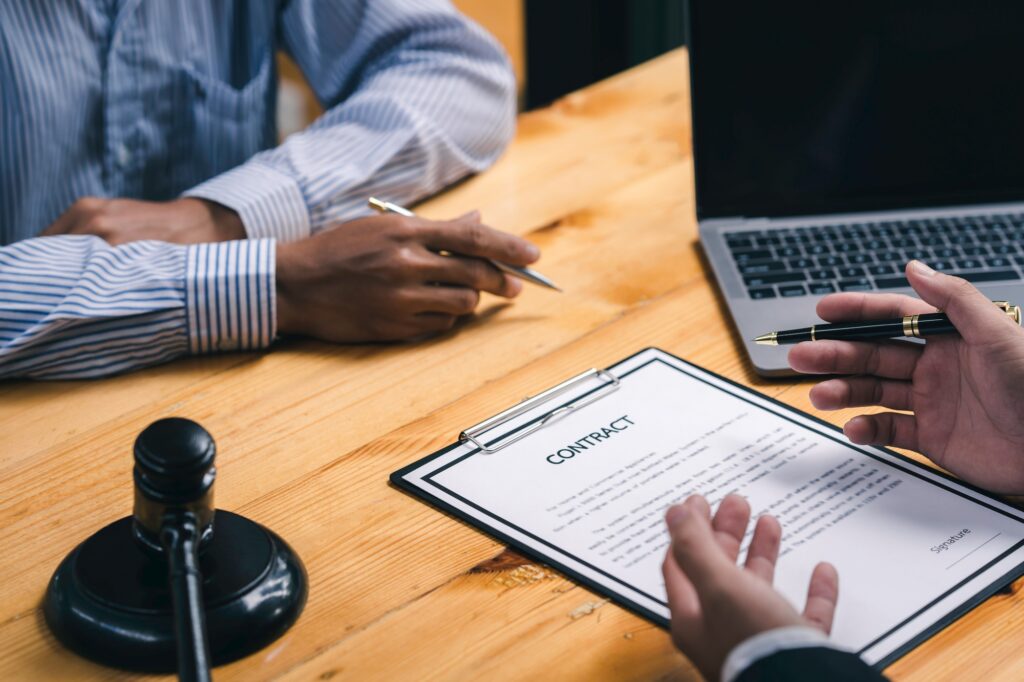 Male Notary lawyer or judge consult or discussing contract papers with Businessman client in the off